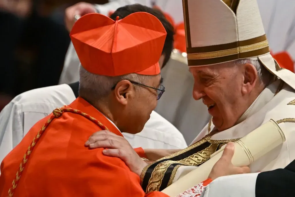 Pope Francis speaks to Archbishop William Seng Chye Goh (left) after he elevated him to cardinal during a consistory to create 20 new cardinals on Aug. 27, 2022, at St. Peter’s Basilica at the Vatican. / Credit: Alberto Pizzoli