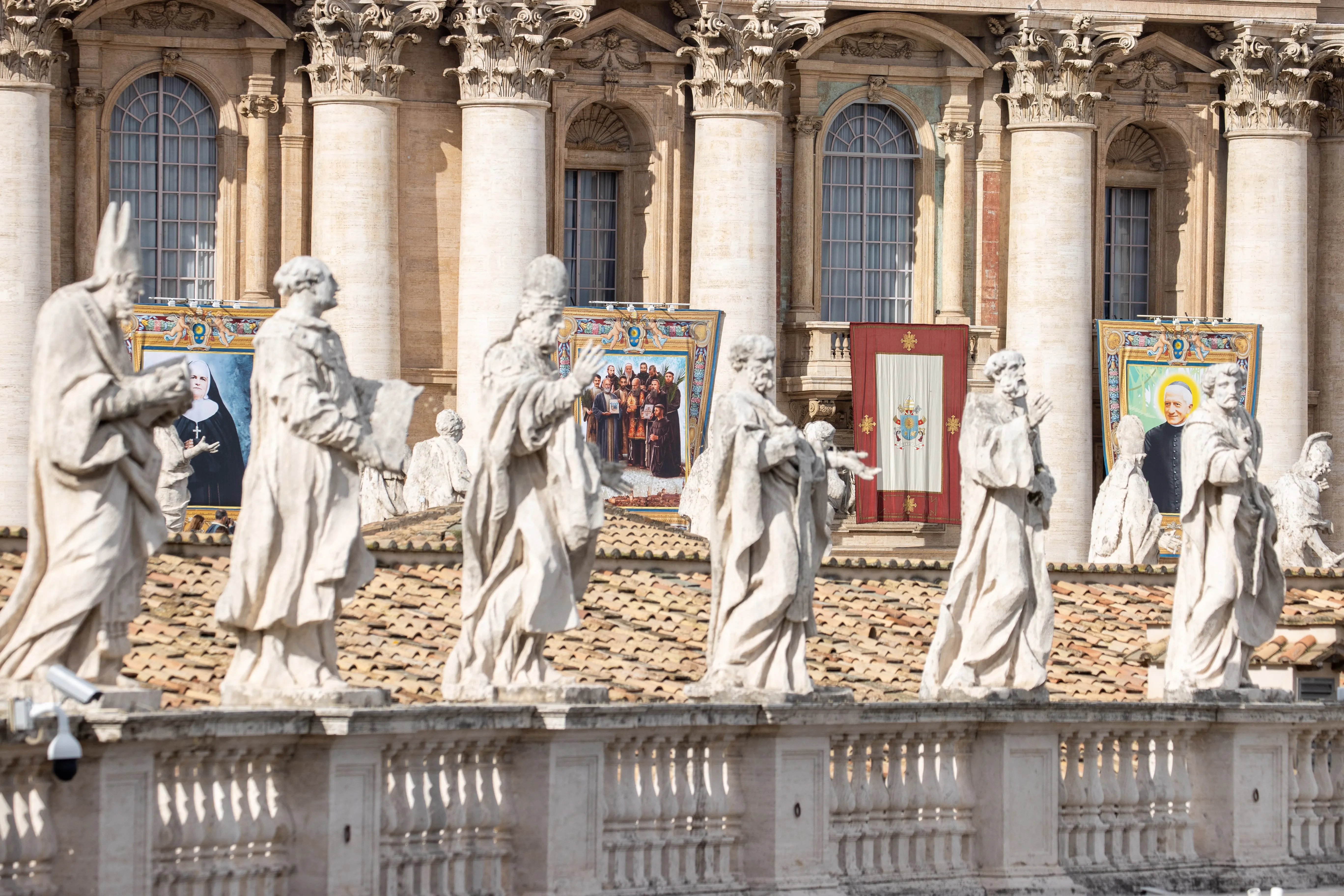 Statuary sits before imagery of the recently canonized saints in St. Peter's Square at the Vatican, Sunday, Oct. 20, 2024 / Credit: Daniel Ibáñez/CNA