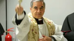 The then Archbishop Angelo Becciu blesses the Pilgrimage Information Center for the Extraordinary Jubilee of Mercy on Dec. 1, 2015. Credit: Daniel Ibáñez/CNA.