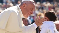 Pope Francis greets a child at a general audience at the Vatican, April 20, 2016. Vatican Media.