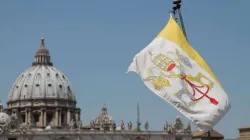 The flag of Vatican City with St. Peter’s Basilica in the background. Credit: Bohumil Petrik/CNA.