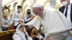 Pope Francis blesses a young boy in the Syriac Catholic Church of the Immaculate Conception in Bakhdida, Iraq, on March 7, 2021. Photo credits: Vatican Media.