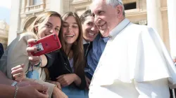 Pope Francis takes a selfie with pilgrims at the April 1, 2015 general audience in St. Peter’s Square. Vatican Media.