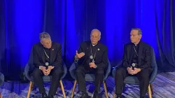 USCCB president Archbishop Timothy Broglio (left); Bishop Mark Seitz, head of the USCCB migration committee (center); and Bishop Michael Burbidge, chairman of the USCCB’s pro-life committee, speak to media at the USCCB fall plenary assembly on Nov. 12, 2024.   / Credit: Jonathan Liedl