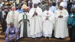 From left: Archbishop Fontem, Cardinal Tumi, and Bishop Bushu, priests standing by.