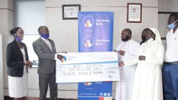 Centenary Bank Managing Director Fabian Kasi (2nd Left), Centenary , handing over a dummy cheque worth UGX10 million (US$2,700.00)  to the Nkozi Hospital Team.