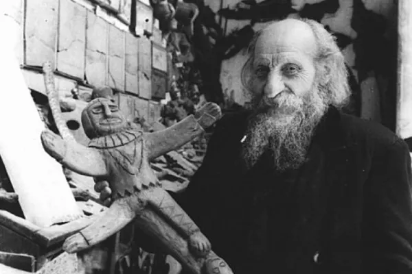 Father Carlo Crespi Croci (1891-1982) holding a crucifix from his ethnographic collection in Cuenca, Ecuador. | Credit: Salesianos de Don Bosco, CC BY-SA 4.0, via Wikimedia Commons