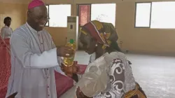 Archbishop Ignatius Ayau Kaigama handing food items to one of the IDPs who visited him on March 2. Credit: Abuja Archdiocese