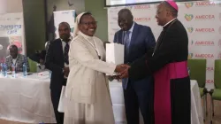 Sr. Beatrice Mary, presenting a gift to Archbishop Muheria during the September 24-26 workshop on child care reforms. Credit: ACI Africa