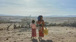 A woman and a girl in Tigray walk with supplies. The founder and CEO of the global school-feeding charity Mary’s Meals visited northern Ethiopia in March and confirmed reports of a widespread hunger crisis unfolding rapidly in Tigray in the aftermath of a two-year civil war and ongoing drought.  / Credit: Armstrong Studios/2024