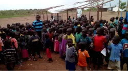 Fr. Lazar Arasu, the Director of Don Bosco Palabek Refugee Services with school children at Palabek refugee camp. / Don Bosco Palabek Refugee Services