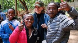 Street children that are part of the Nairobi-based Alfajiri Street Kids Art pose for a photo with the founder of the facility, Australian-born Lenore Boyd (at the back) / Joost Bastmeijer for Beyond the Orphanage