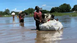 Heavy rain and severe flooding in South Sudan, last week have caused severe damage to camps for refugees and internally displaced persons. Thousands of people, such as this mother and her children, have been forced to seek higher ground. / Jesuit Refugee Service.