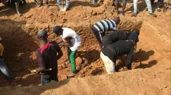 This image grab made from an AFPTV video taken in Maiyanga village, in Bokkos local government, on December 27, 2023 shows families burying in a mass grave their relatives killed in deadly attacks conducted by armed groups in Nigeria's central Plateau State. / Credit: Photo by KIM MASARA/AFPTV/AFP via Getty Images