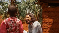 Catholic actor Jonathan Roumie visits Emelyne, a little girl he has sponsored since 2023, in Rwanda. / Credit: Unbound