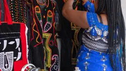 Daniella, an internally displaced girl who participated to the GLOW Camp, working in her traditional sewing business in Cameroon (Jesuit Refugee Service). Credit: JRS