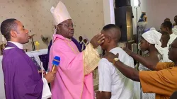 Archbishop Ignatius Ayau Kaigama administers the Sacrament of Confirmation at  Holy Cross Kuchigoro Catholic Parish of Nigeria’s Abuja Archdiocese on 11 December 2022. Credit: Abuja Archdiocese