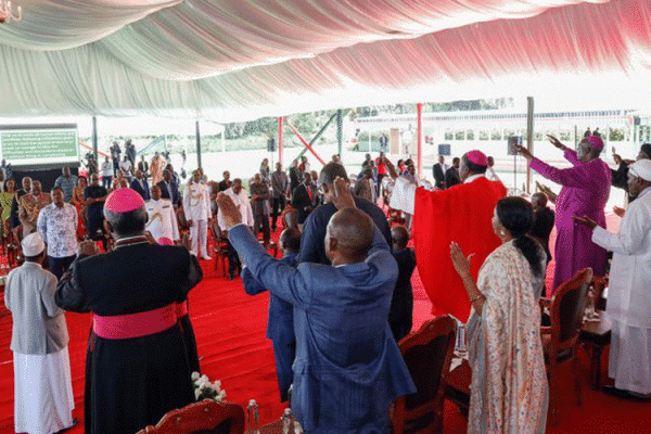 Religious Leaders, dignitaries, and other invited guests raise their hands in a gesture of worship during the National Prayer Day held at State House Nairobi on March 21, 2020. / State House, Nairobi Kenya.