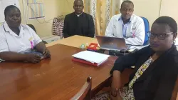 From left to right Judith Anyanje - Senior Nursing Oficer - MCH (Mother to Child Healthcare clinic), Fr. Columban Odhiambo -Hospital Administrator, Dr Aimable Niyubahwe - Medical Officer Incharge, Mirabel Maseghe - a mother of 3, one of whom is vaccinated. Credit: Fr. Columban Odhiambo