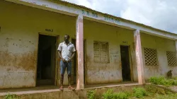 School administrator Patricio Mendes stands outside the school he oversees in Djam-Ma in Guinea-Bissau’s Bafatá region. Credit: Ricci Shryock for CRS