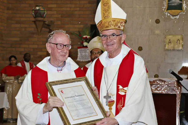Archbishop Stephen Brislin (right) presents Msgr Barney McAleer (left) with a framed certificate in gratitude for his work in Southern Africa.