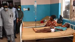 State officials walk past injured victims on hospital beds being treated for wounds following an attack by gunmen at St. Francis Xavier Catholic Church in Owo, southwest Nigeria, on June 5, 2022. | AFP via Getty Images