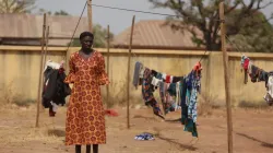 A Christian woman stands next to a clothesline while taking refuge in an internally displaced persons (IDP) camp at the Pilot Primary School after their houses were burnt as a result of religious strife in Mangu on Feb. 2, 2024, following weeks of intercommunal violence and unrest in the Plateau State. / Credit: KOLA SULAIMON/AFP via Getty Images