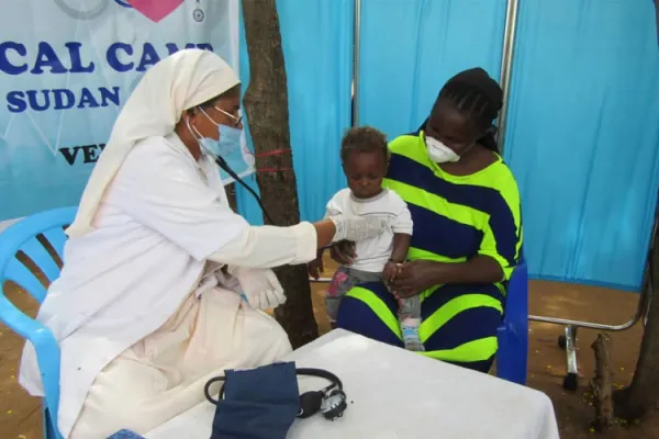 A member of the Society of Daughters of Mary Immaculate and collaborators providing healthcare assistance to a little child / ACI Africa