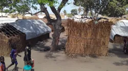 Children walk outside houses at a refugee camp in Pemba/ Credit: Denis Hurley Peace Institute