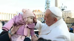 Pope Francis blessing a baby during a general audience. / Credit: Vatican Media