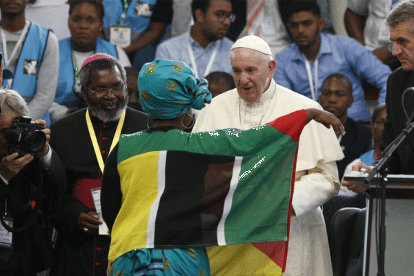 Pope Francis greets a young woman as he leads an interreligious meeting with young people at the Maxaquene Pavilion in Maputo, Mozambique, Sept. 5, 2019.