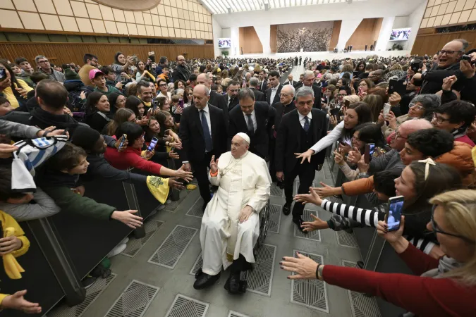 Faithful reach out to greet Pope Francis as he makes his way through the crowd in the Vatican's Paul VI Audience Hall during the first Jubilee audience of 2025.