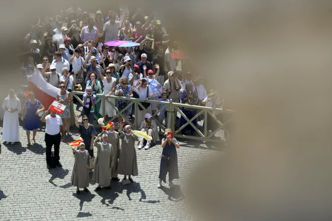 Religious sisters wave Spanish flags at Pope Francis during his weekly Angelus in St. Peter's Square on Sunday, July 21, 2024.