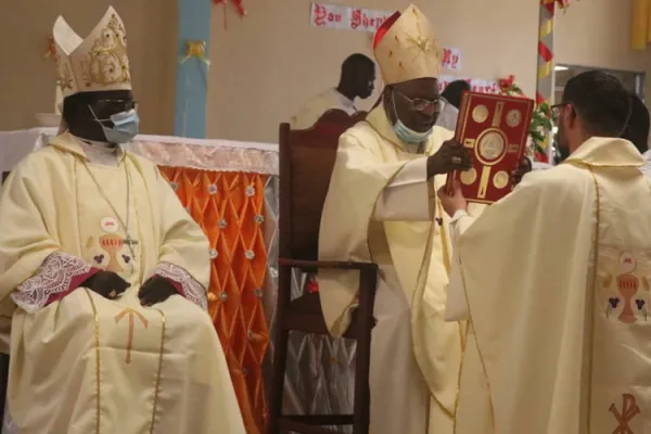Bishop Carlassare receives the Holy Bible from Gabriel Cardinal Zubeir Wako during the March 25 Episcopal Ordination held at Holy Father Cathedral of the Diocese of Rumbek. Credit: Courtesy Photo