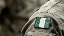 The flag of Nigeria on a military uniform. | Bumble Dee/Shutterstock.