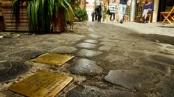 "Stumbling blocks" in Rome, Italy. Plates inscribed with the name and dates of life of the victim of Nazi persecution. | Shutterstock