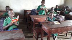 Children at St Teresa of the Child Jesus Parish in Bo. Sierra Leone reading Child'sBible, "God speaks to His children." / Aid to the Church in Need (ACN).