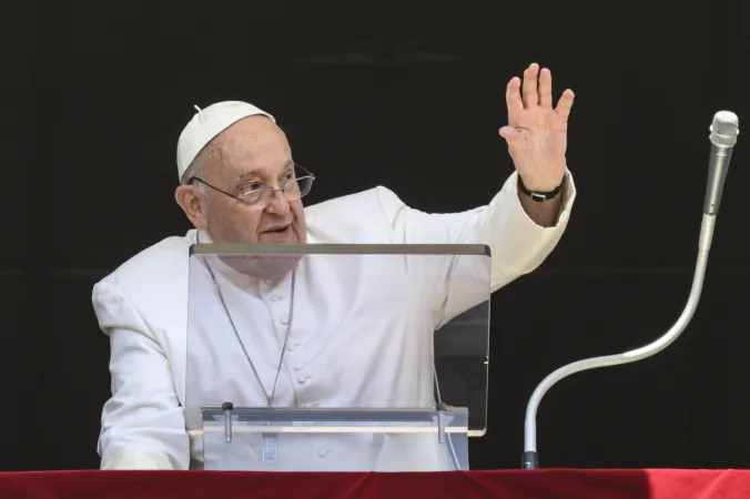 Pope Francis waves to crowds before his noon Angelus address during a hot day in Rome on July 14, 2024.