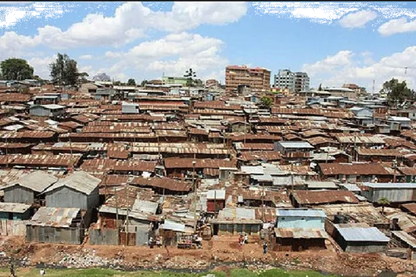 Image showing an open sewer running behind numerous corrugated houses at Mukuru kwa Njenga in Nairobi, Kenya. / courtesy