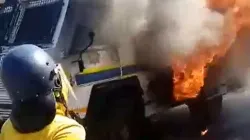 A man wearing a helmet approaches a burning van in Johannesburg
Credit: Denis Hurley Peace Institute