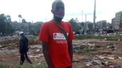 Teacher Stephen Mwangi at the ruins in Kariobangi North. Also visible are homeless families that were spending nights in the cold after their houses were destroyed. / Stephen Mwangi