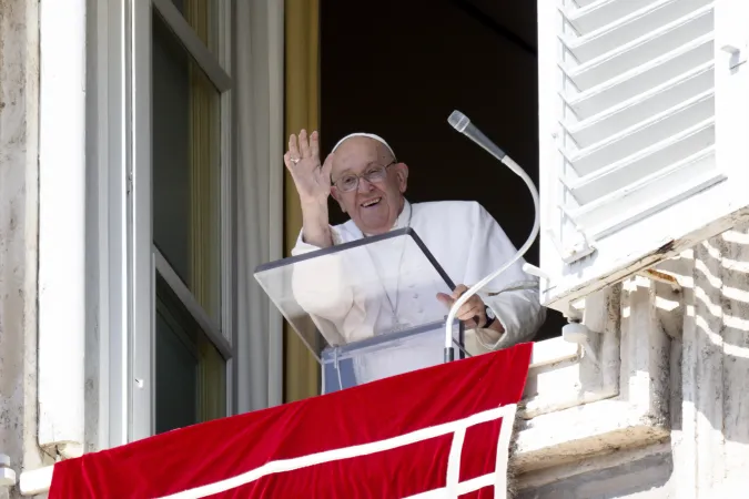 Pope Francis smiles and waves from a window of the Apostolic Palace to those gathered in St. Peter's Square for his weekly Angelus address on Sept. 15, 2024.