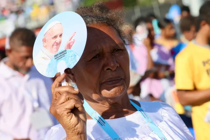 A woman holds a fan featuring Pope Francis during Mass with the Roman pontiff at Sir John Guise Stadium in Port Moresby, Papua New Guinea, Sept. 8, 2024