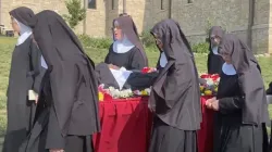 Religious sisters of the Benedictines of Mary, Queen of Apostles, sing as the process with the body of their late foundress, Sister Wilhelmina Lancaster, on May 29, 2023, at their abbey near Gower, Missouri. The sisters exhumed the nun's body on May 18 and discovered that it was apparently intact, four years after her death and burial in a simple wooden coffin. | Joe Bukuras/CNA