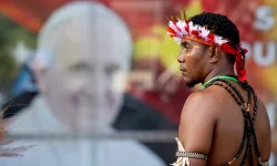 A man stands in front of a poster of Pope Francis outside APEC Haus in Port Moresby, Papua New Guinea, to welcome the Roman pontiff, Sept. 7, 2024. / Credit: Daniel Ibáñez/CNA