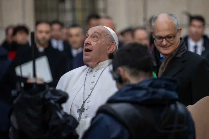 Pope Francis gazes up at the bronze statue of Mary atop the 39.4-foot column at Rome's Spanish Steps, Dec. 8, 2024.