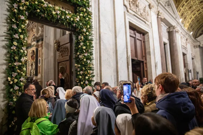 Faithful gather at the flower-adorned Holy Door of the Basilica of St. Mary Major in Rome on Jan. 1, 2025, as the Jubilee Year gets underway.