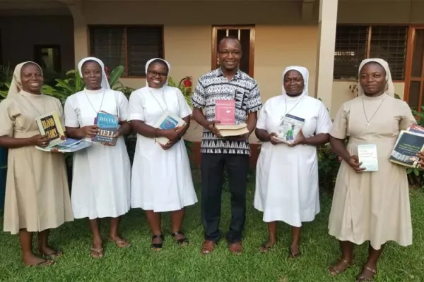 Sisters of the Congregation of the Handmaids of Divine Redeemer (HDR) posing with some of the Books they presented to Fr. Patrick Tindana, Director of Mission of Office of the Accra Archdiocese at the Holy Spirit Cathedral, Adabraka, Accra, Ghana / Mission Office, Accra Archdiocese