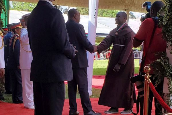 Br. Peter Mokaya Tabichi, World’s Best Teacher receiving the Moran of the Order of the Burning Spear at Kenya's State House from President Uhuru Kenyatta on Jamhuri Day, December 12, 2019 / Presidential Press