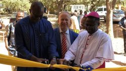 Bishop Alexandre Yikyi Bazié (right), Ambassador Ingo Herbert (Center) and  Adegbola Fasutin Adeye (left) cutting the inauguration ribbon of the new headquarters of CJP-Burkina in Ouagadougou on Tuesday December 3, 2019 / CJP-Burkina